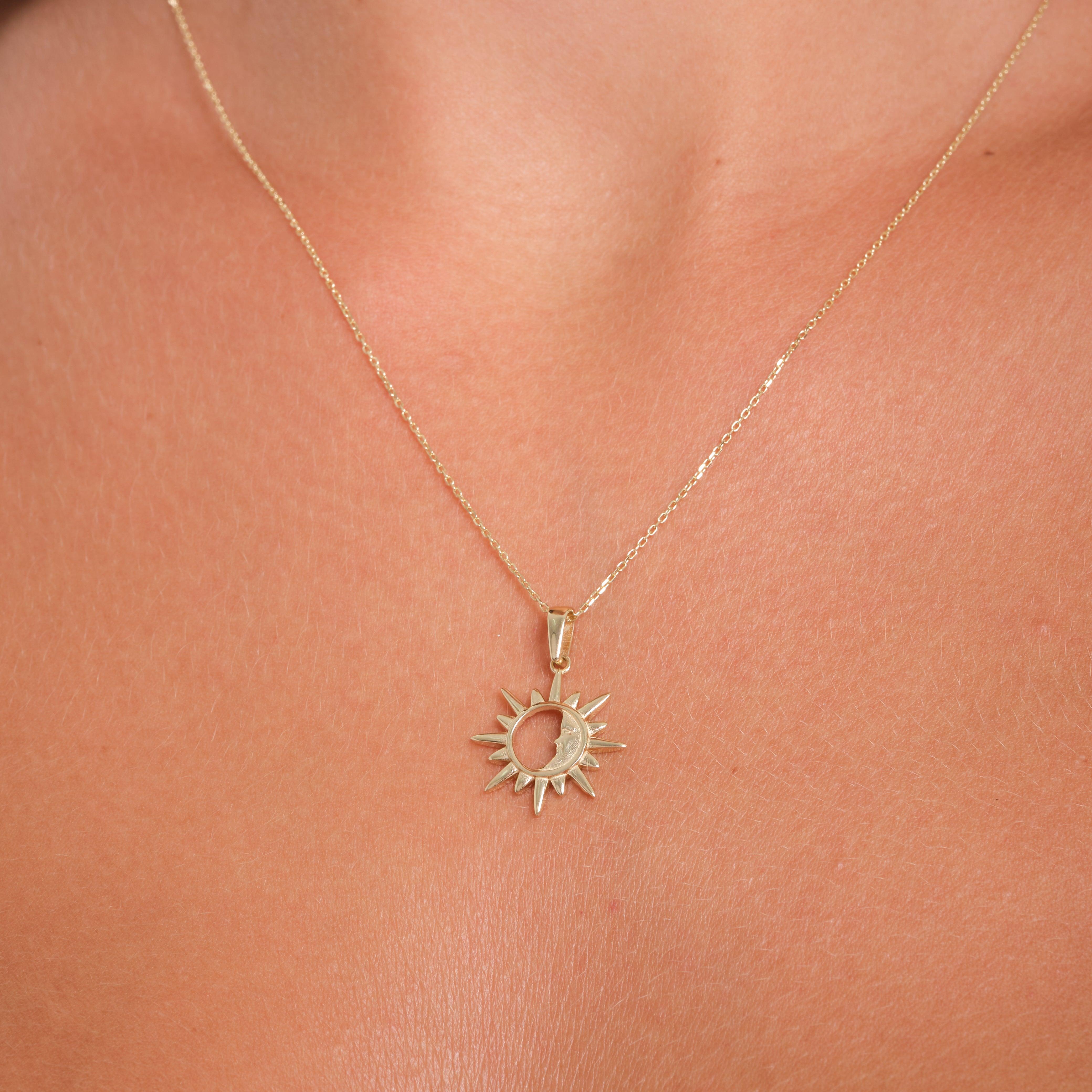Gold sun pendant necklace on a woman's neck, fine jewelry with celestial design.