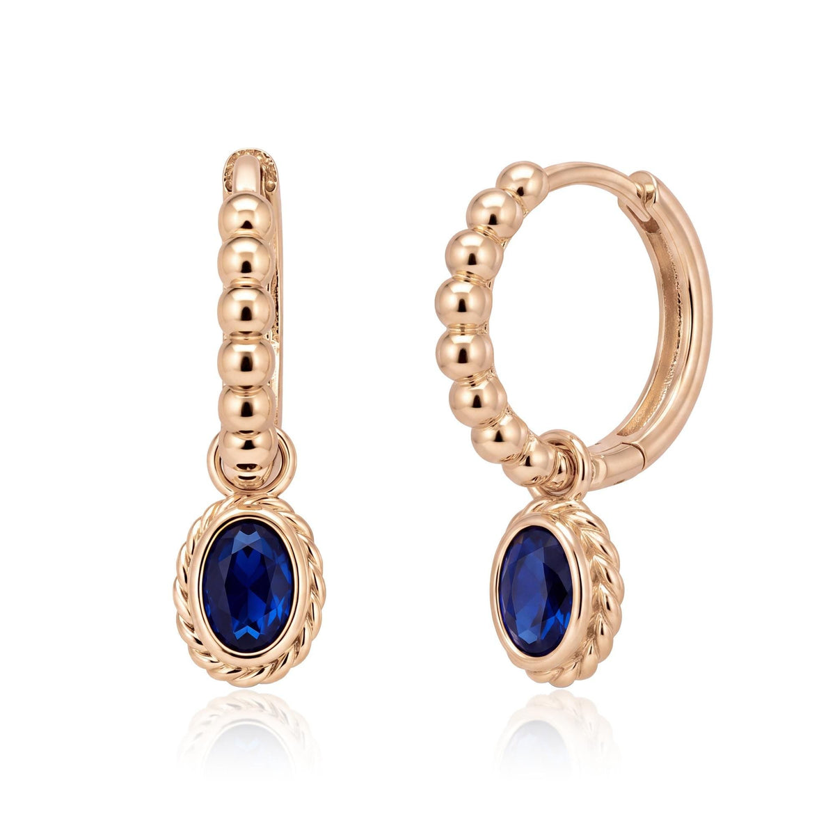 Pair of 14K rose gold beaded huggie earrings with oval blue stone drops and twisted rope bezel