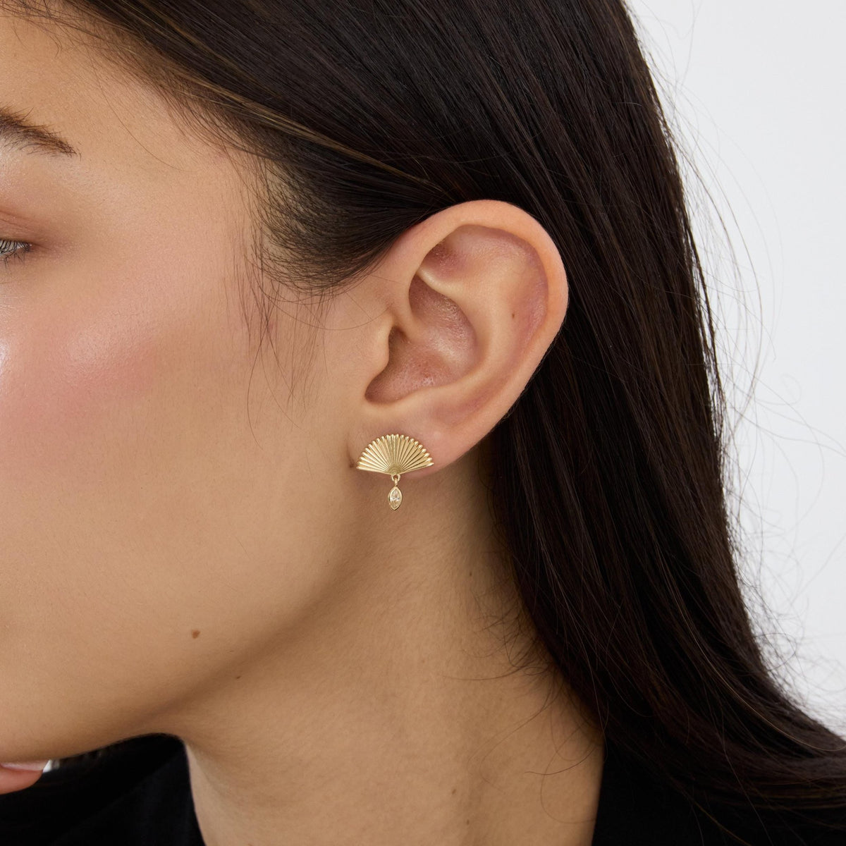 14K gold fan drop stud earring with marquise cubic zirconia worn on ear, side profile close-up