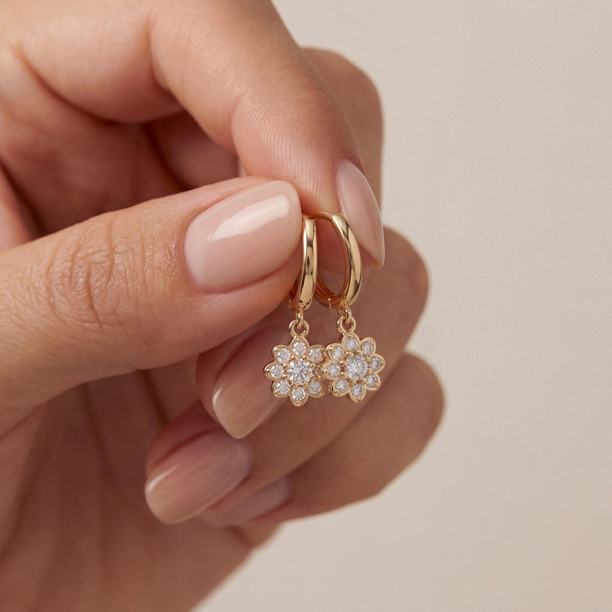 14K gold floral huggies earrings, styled view