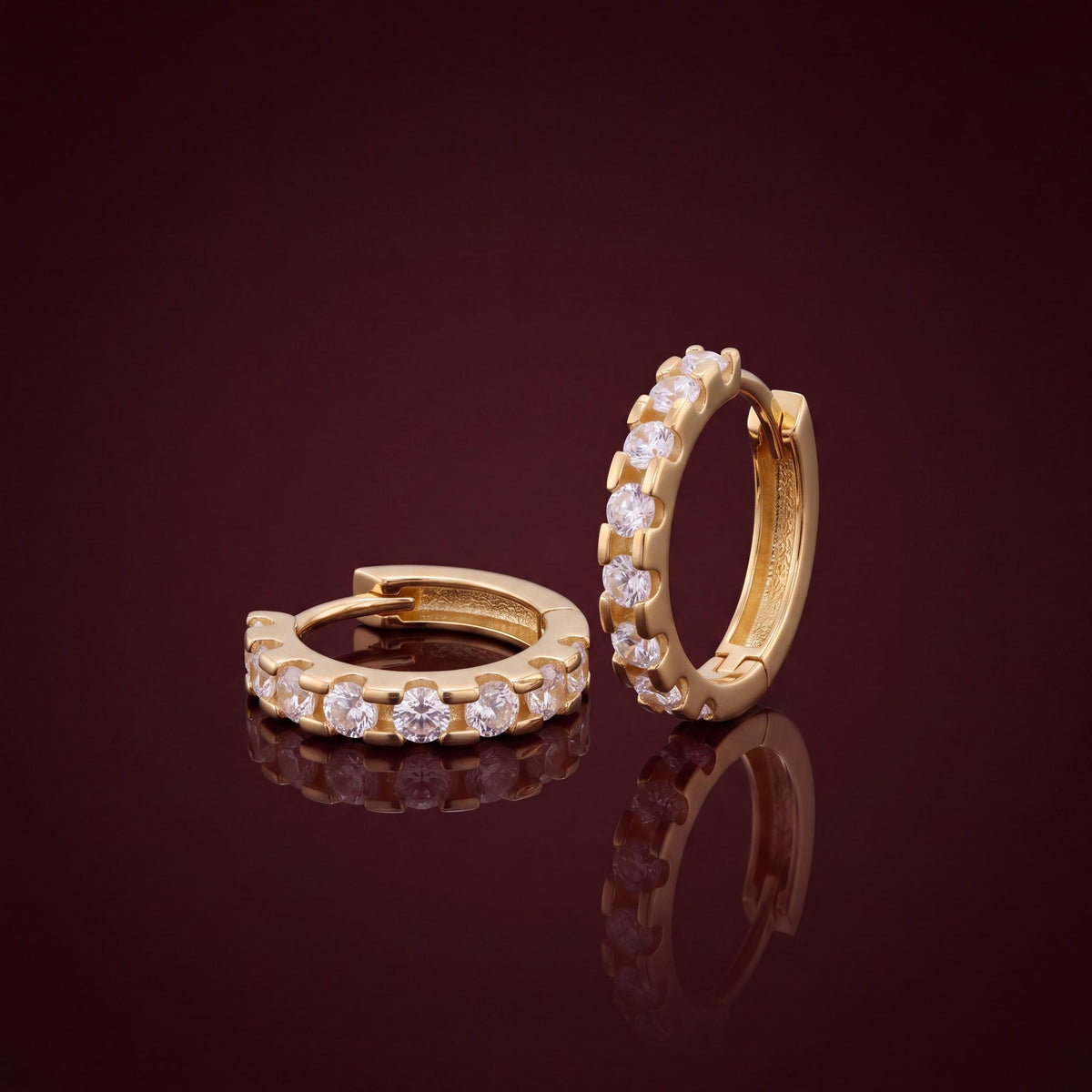 14K gold huggie hoop earrings, styled view