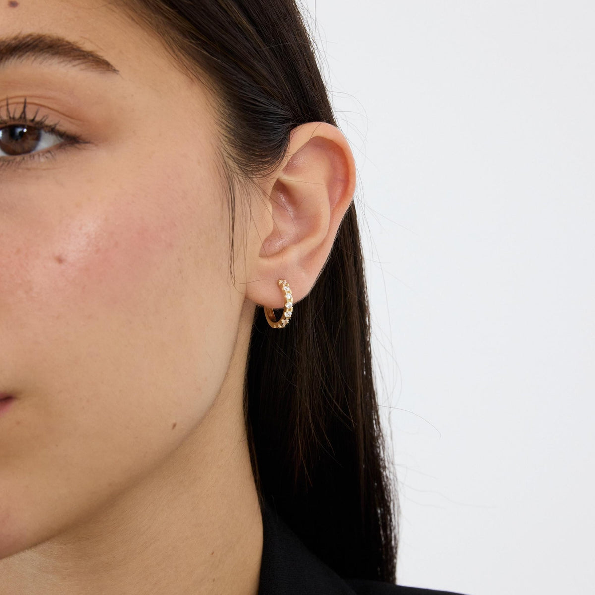 14K gold huggie hoop earrings, styled view