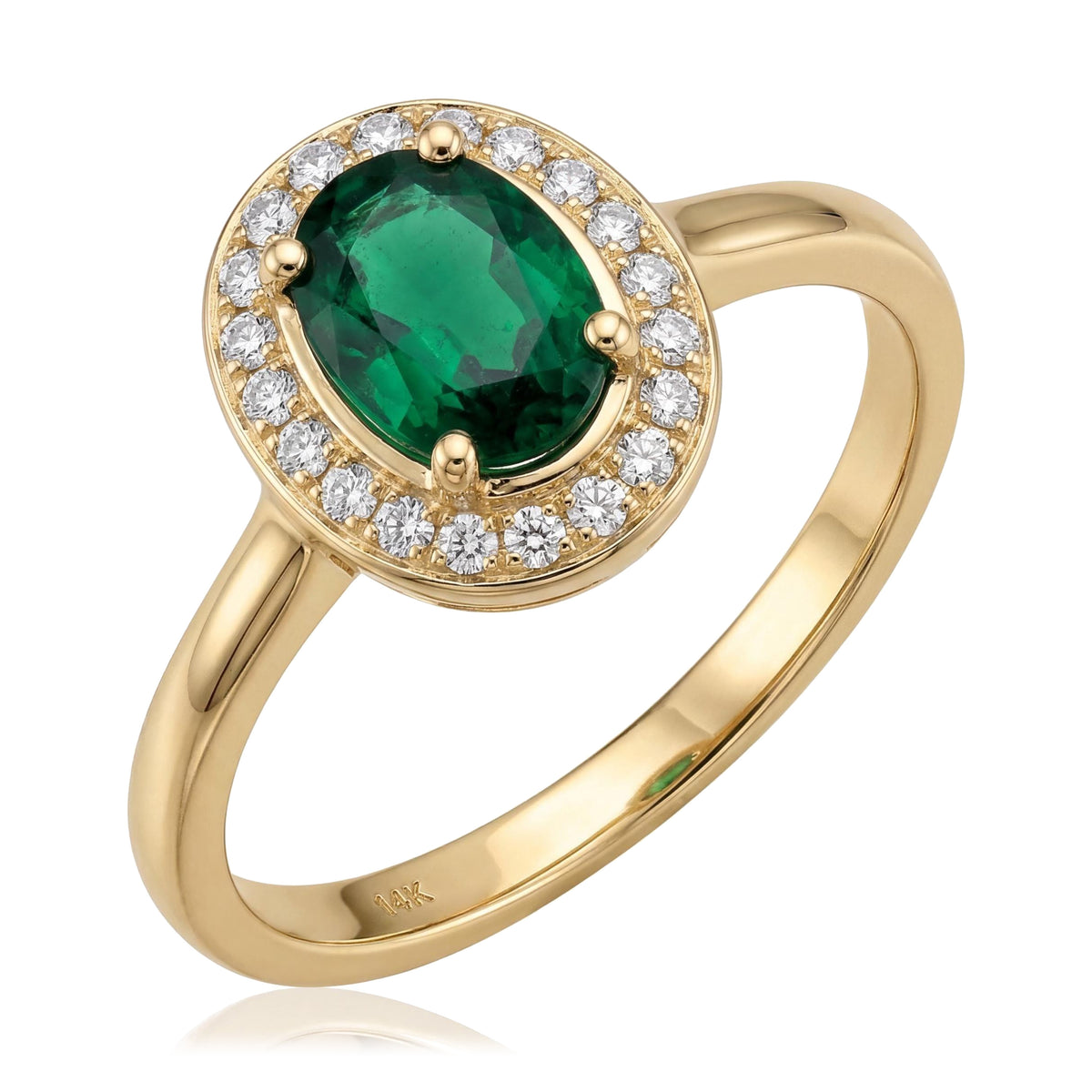 14K yellow gold simulated emerald ring, oval green stone in a halo of small clear stones, angled on white