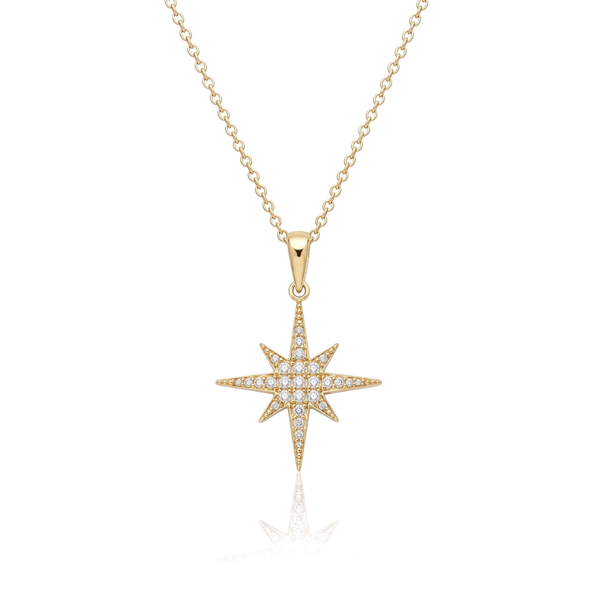 14K yellow gold North Star necklace, eight-point star pendant paved with clear stones, on white