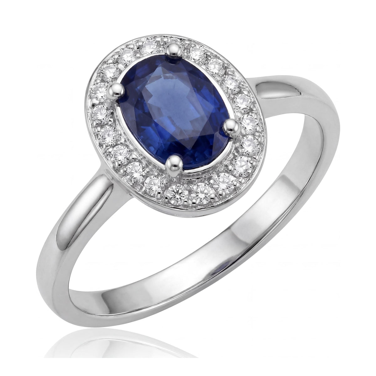 14K white gold simulated sapphire ring, oval blue stone in a halo of small clear stones, angled on white