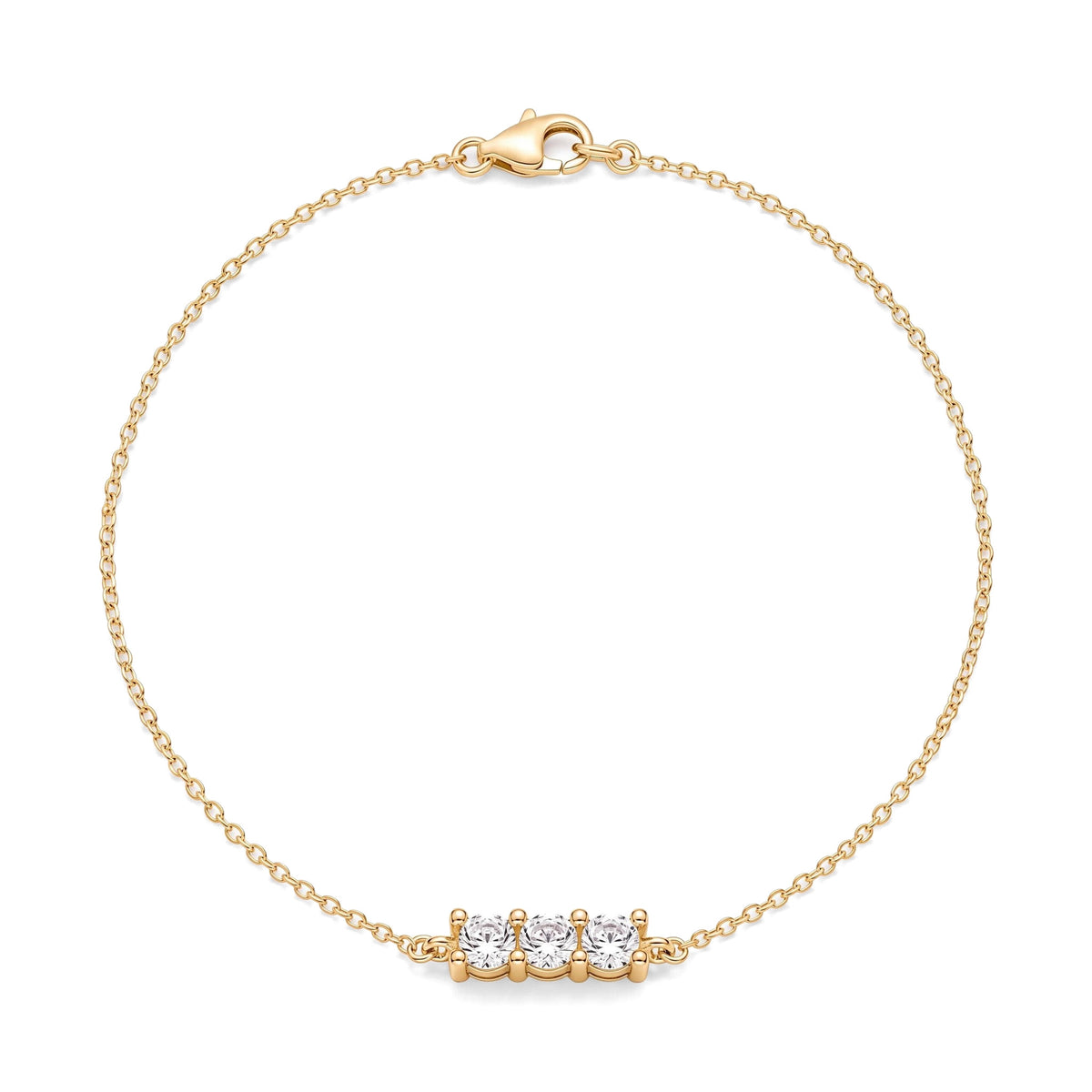 14K yellow gold three stone bracelet, three round cubic zirconia in a bar on a fine cable chain, on white