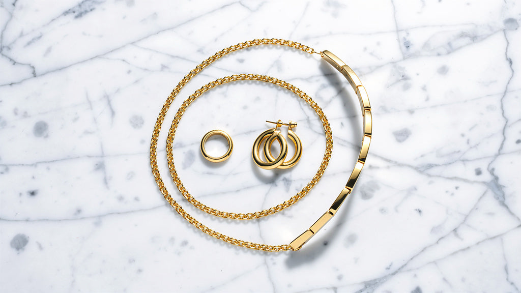Collection of solid gold jewelry pieces representing a luxury jewelry brand