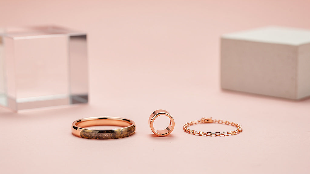 Copper bracelet, ring, and necklace shown together, one polished bright and one tarnished