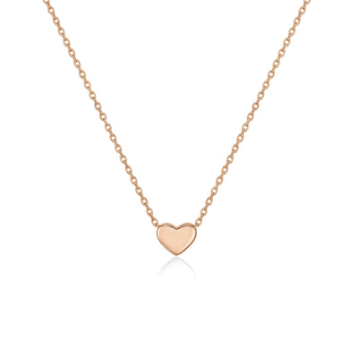 14K rose gold heart necklace, tiny polished heart fixed on a fine cable chain, close-up on white