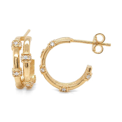 Pair of 14K yellow gold bamboo hoop earrings with round cubic zirconia, front and side view on white
