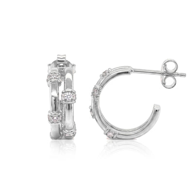 Pair of 14K white gold bamboo hoop earrings with round cubic zirconia, front and side view on white