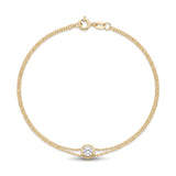 14K yellow gold bezel bracelet, double cable chain with one round bezel-set clear stone, on white