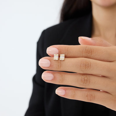 14K gold cluster stud earrings with cubic zirconia held on fingers, second angle of the hand shot