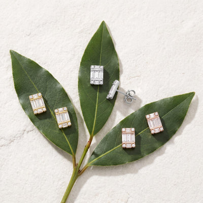 14K cluster stud earrings with cubic zirconia in yellow, white and rose gold arranged on green leaves