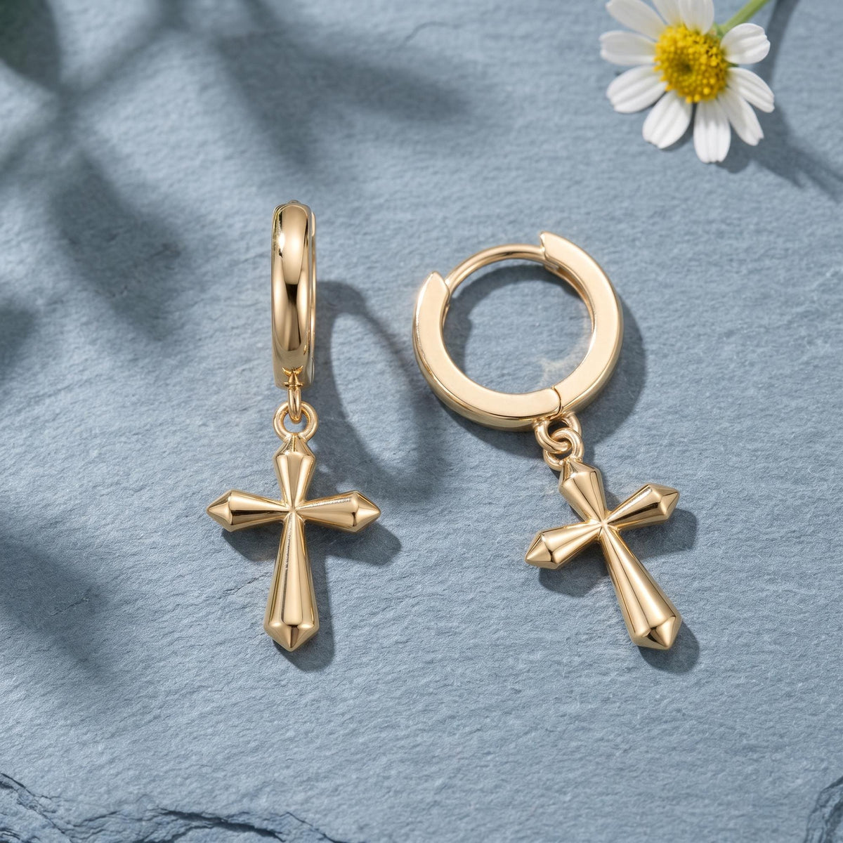 14K gold cross hoop earrings styled on a neutral backdrop