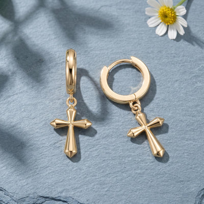 14K gold cross hoop earrings styled on a neutral backdrop