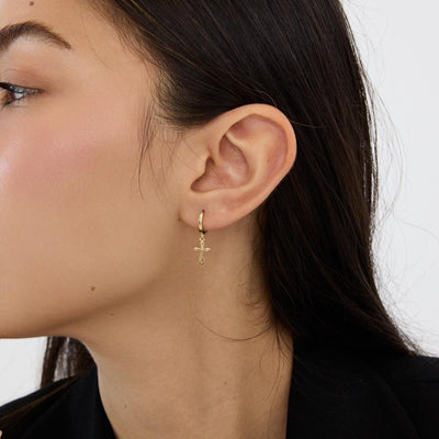 14K gold cross hoop earrings styled on a neutral backdrop, second angle