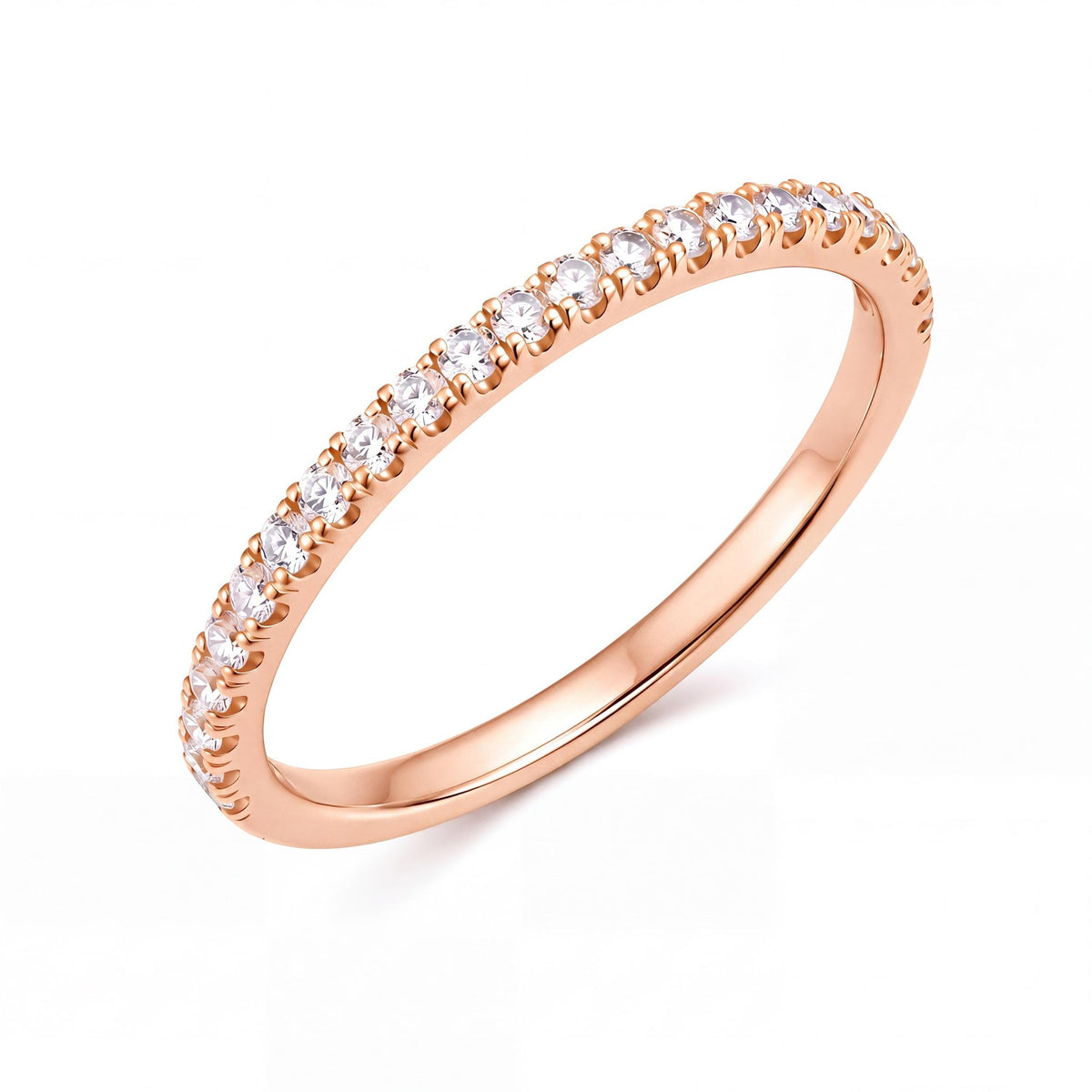 14K rose gold half eternity ring with a row of round cubic zirconia, angled view on white