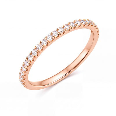 14K rose gold half eternity ring with a row of round cubic zirconia, angled view on white