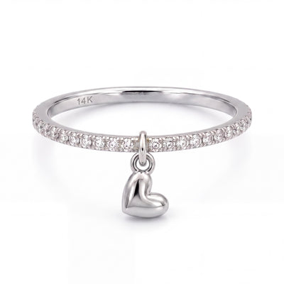 14K white gold heart charm ring, clear stone band with a dangling puffed heart, front view on white