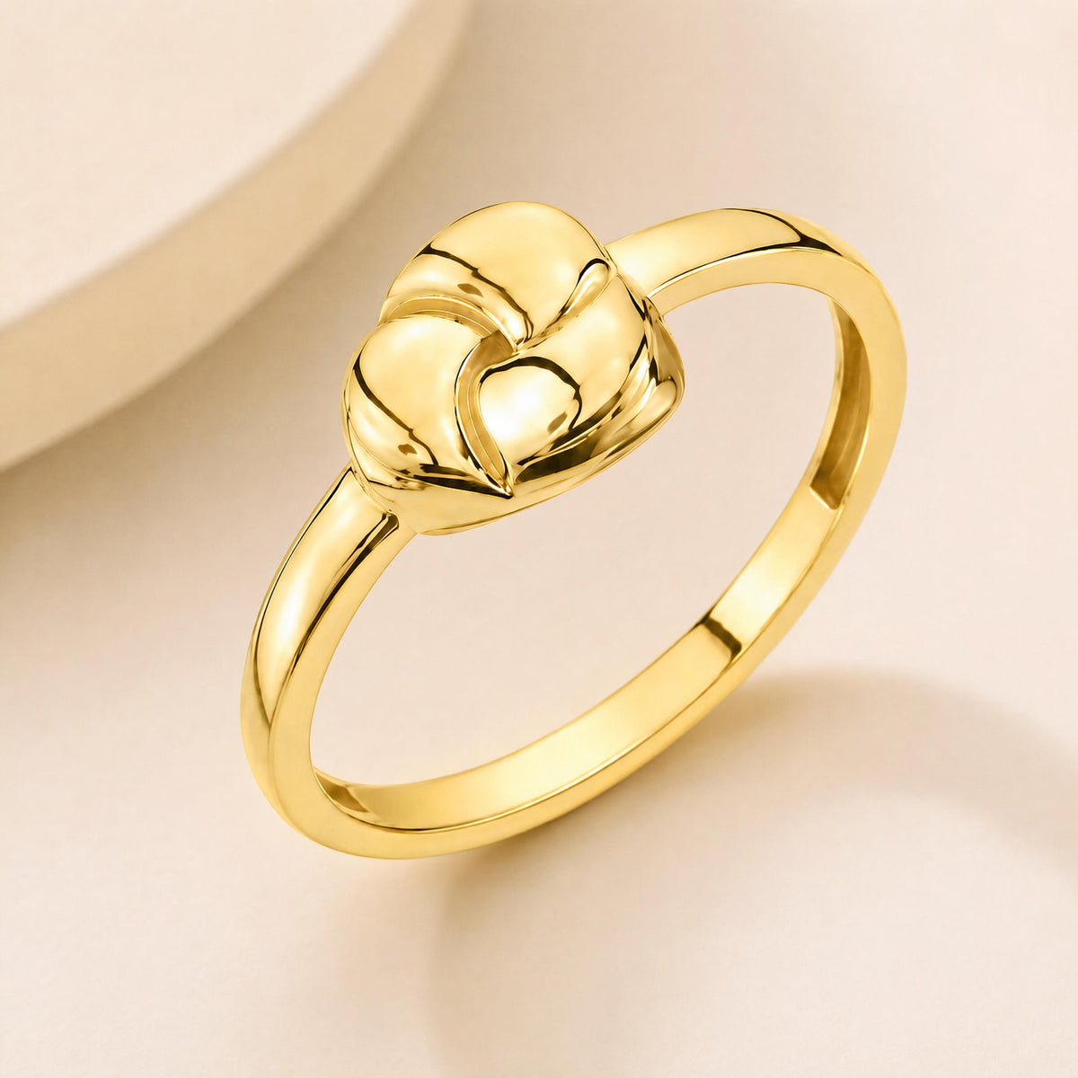 14K gold heart dome ring, angled flat lay showing domed knot design