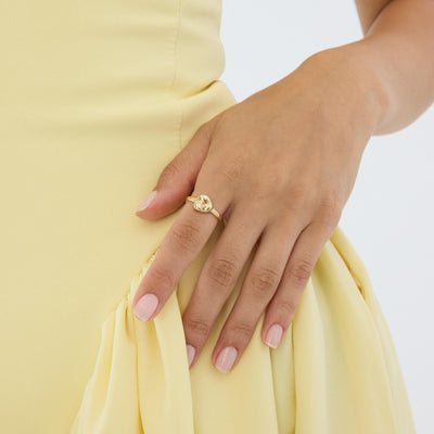 14K gold heart dome ring on hand resting against hip in yellow dress