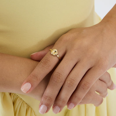 14K gold heart dome ring worn on clasped hands, close-up angle