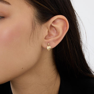 14K gold heart drop stud earring with cubic zirconia worn on the ear, side profile close-up