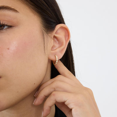 14K gold huggie hoop earrings, styled view