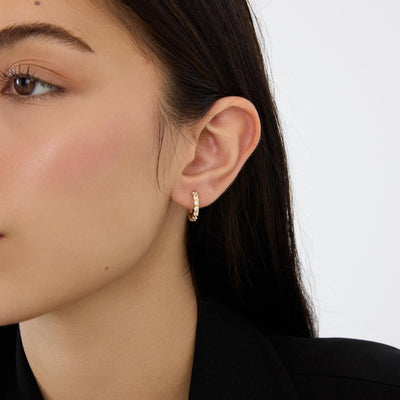 14K gold huggie hoop earrings, styled view