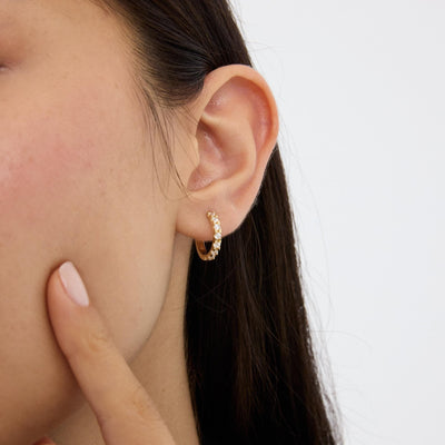 14K gold huggie hoop earrings, styled view
