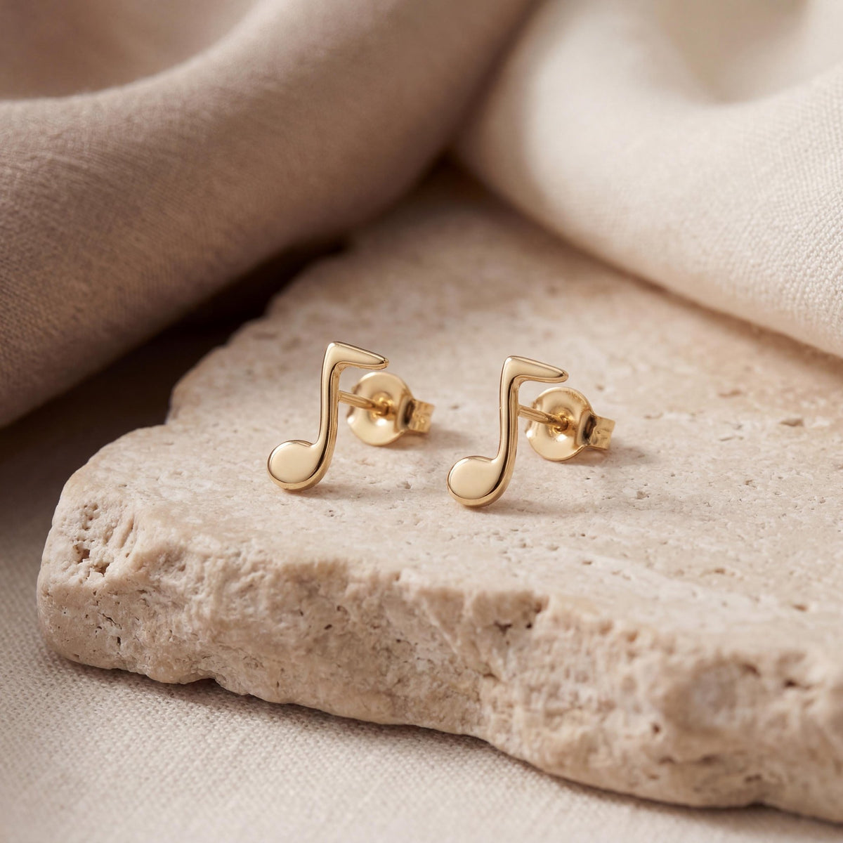 14K gold music note stud earrings, styled view