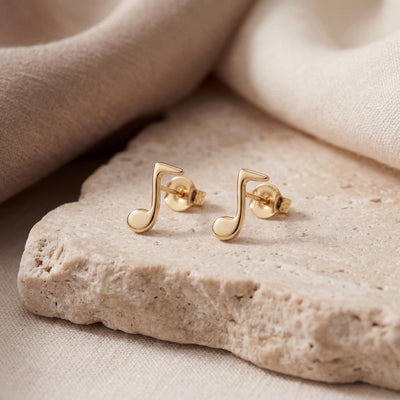 14K gold music note stud earrings, styled view