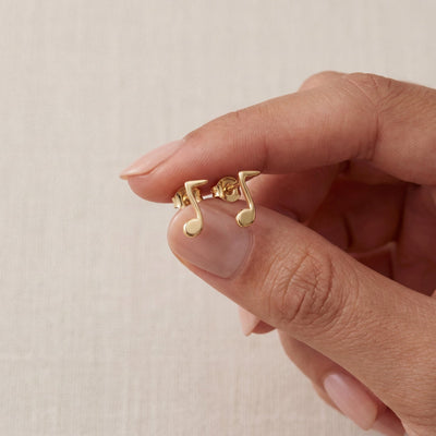 14K gold music note stud earrings, styled view