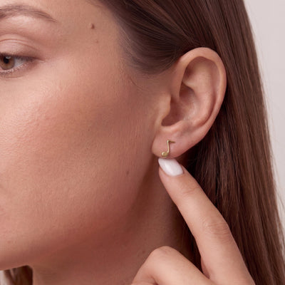 14K gold music note stud earrings, styled view