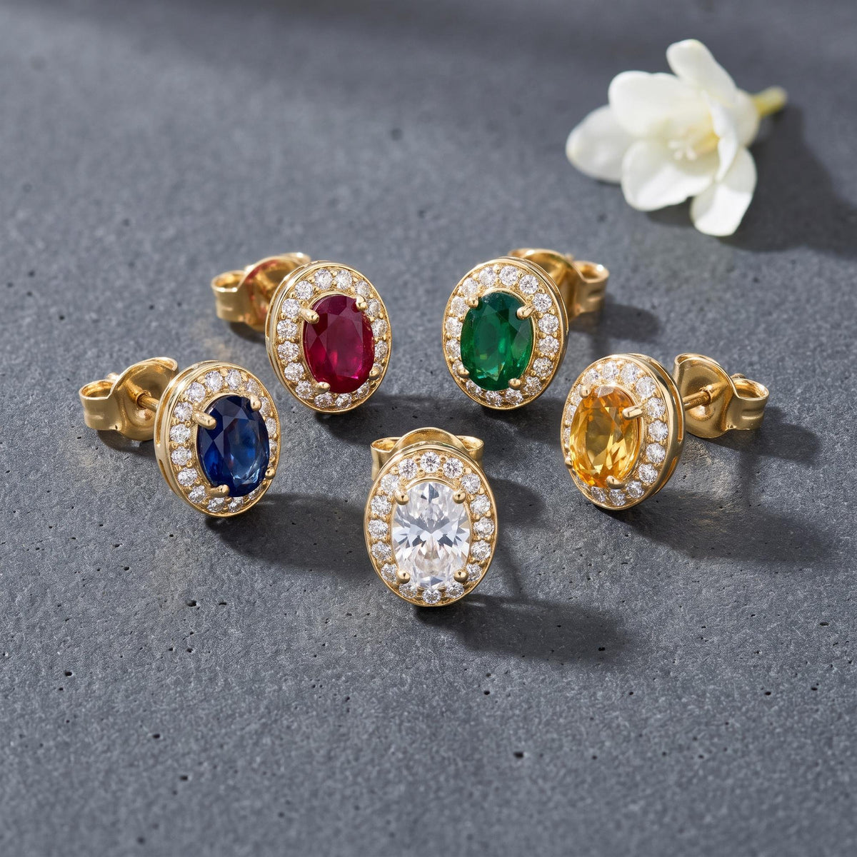 14K gold oval stud earrings styled on a neutral backdrop