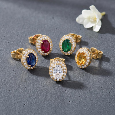 14K gold oval stud earrings styled on a neutral backdrop