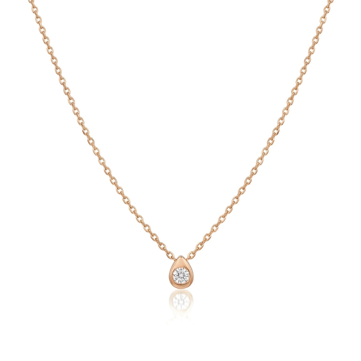 14K rose gold pear drop necklace, small teardrop pendant with a bezel-set clear stone, on white