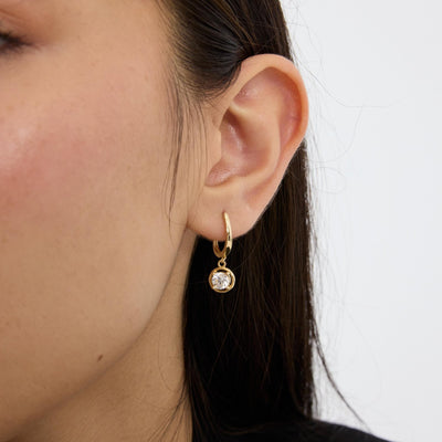 14K gold round cz solitaire drop hoop earrings, styled view