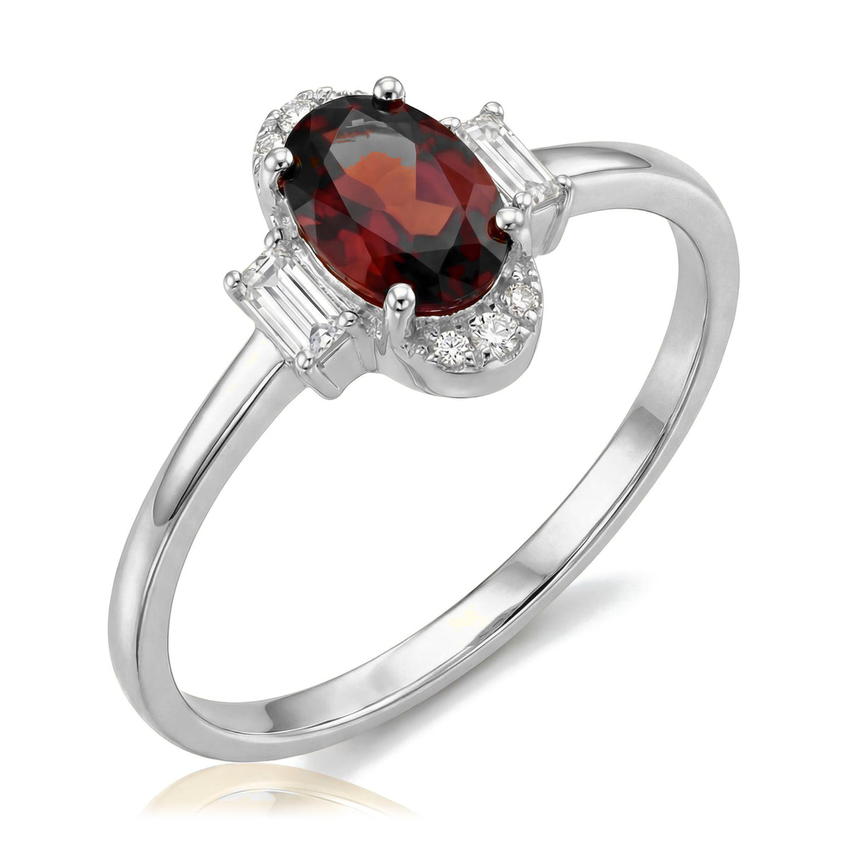14K white gold simulated ruby ring, oval dark red stone flanked by baguette accents, angled view on white