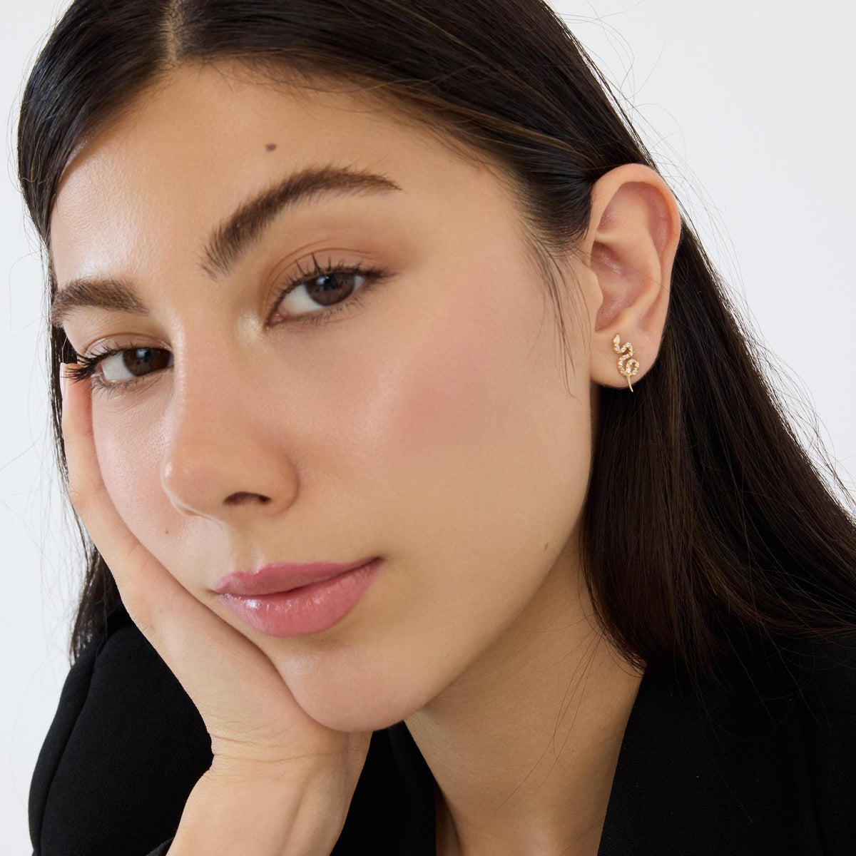 14K gold snake stud earrings styled on a neutral backdrop, fourth angle