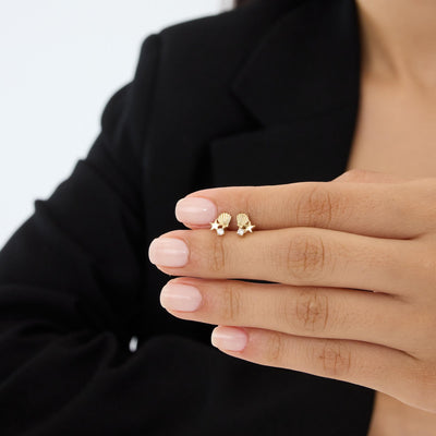 14K gold starfish stud earrings with cubic zirconia on fingertips, second hand-held scale view