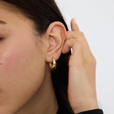 14K gold tapered hoop earrings, side view beside open hoop with post and butterfly back on white