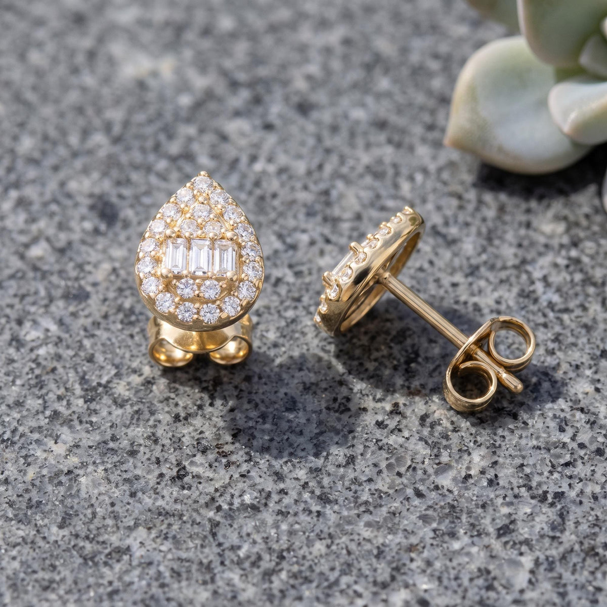 14K gold teardrop stud earrings styled on a neutral backdrop