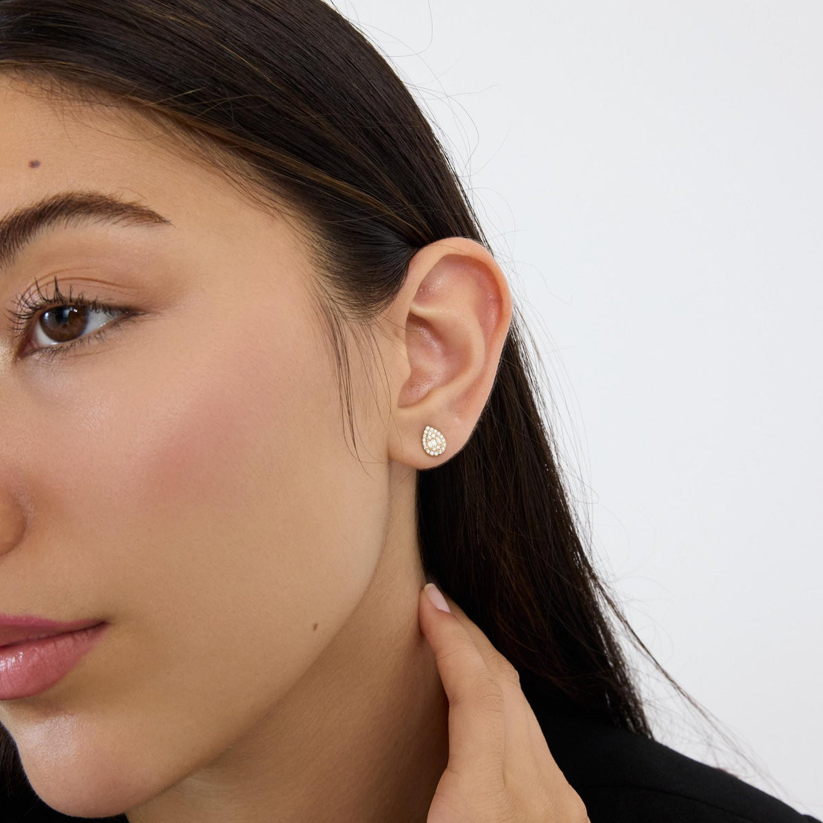 14K gold teardrop stud earrings styled on a neutral backdrop, fifth angle